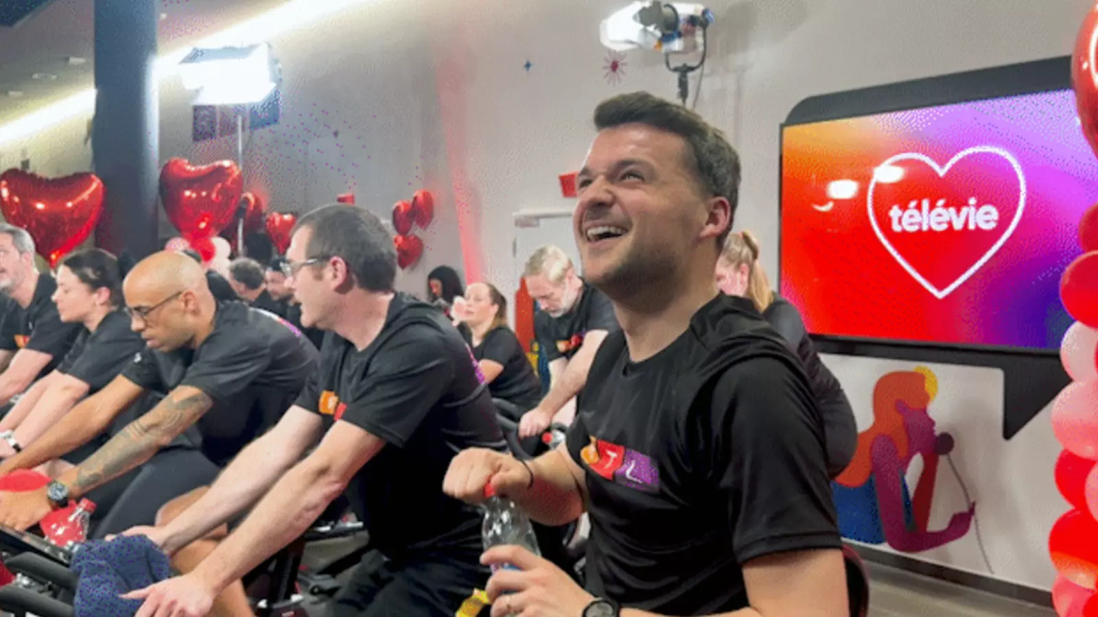 People wearing RTL T-shirts on exercise bikes