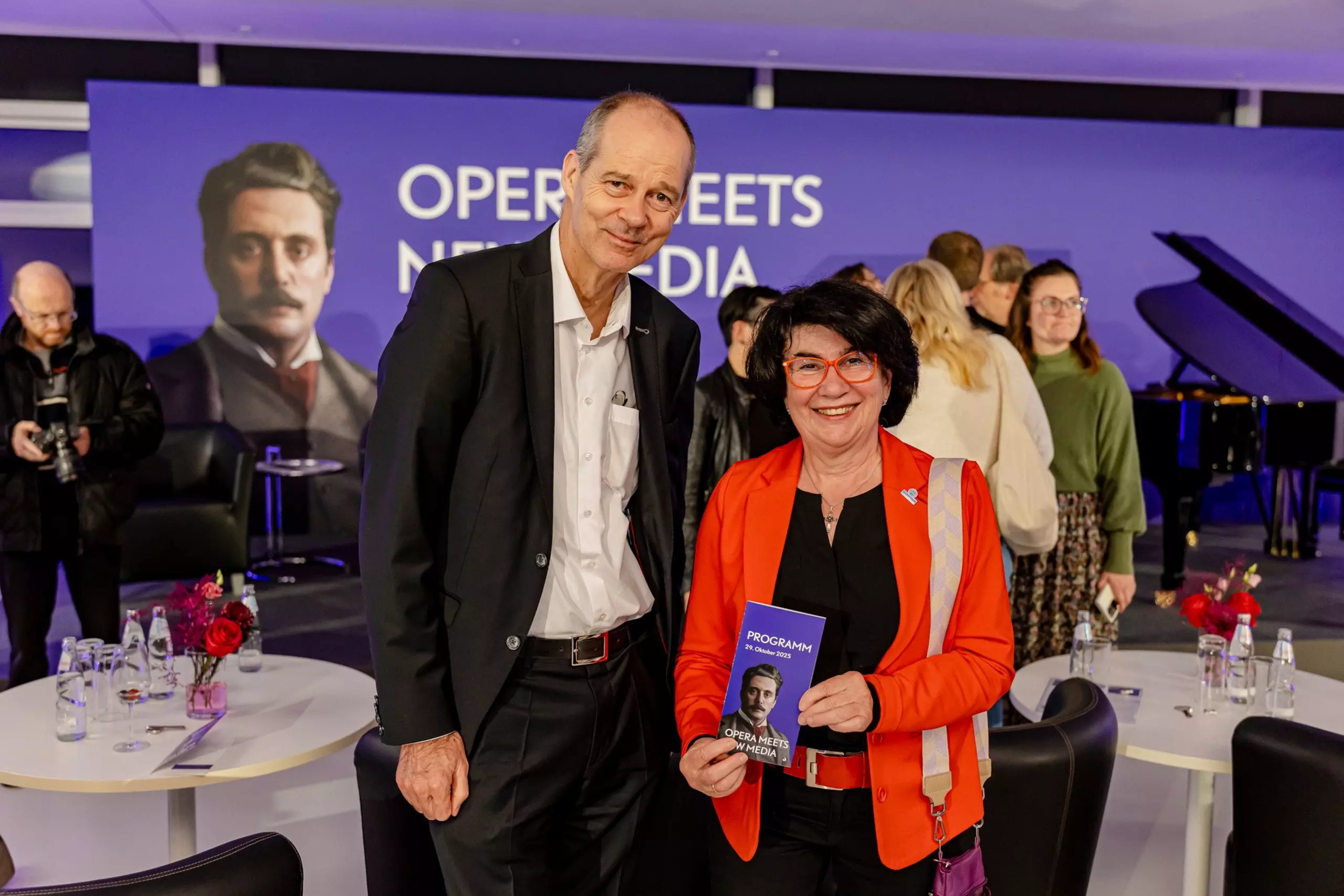 Christoph Mohn and Maria Unger, holding the program booklet for the opening ceremony