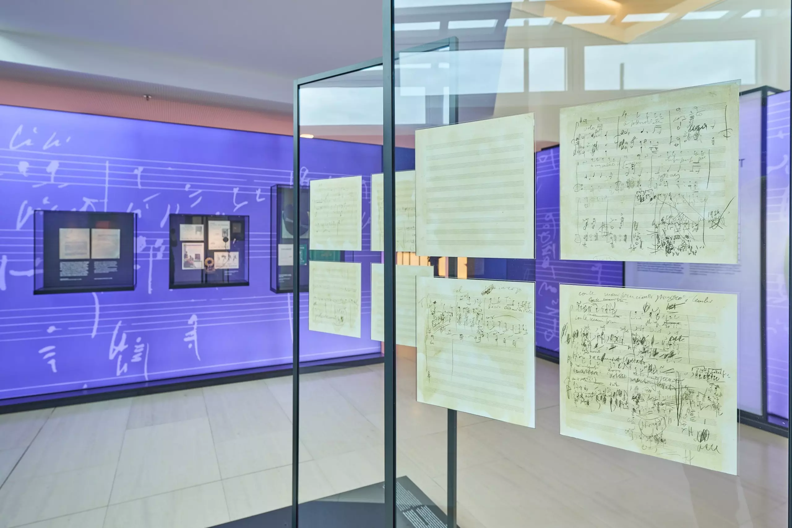 Original Turandot sheet music in tall glass frames in the middle of the exhibition, which visitors can view from both sides