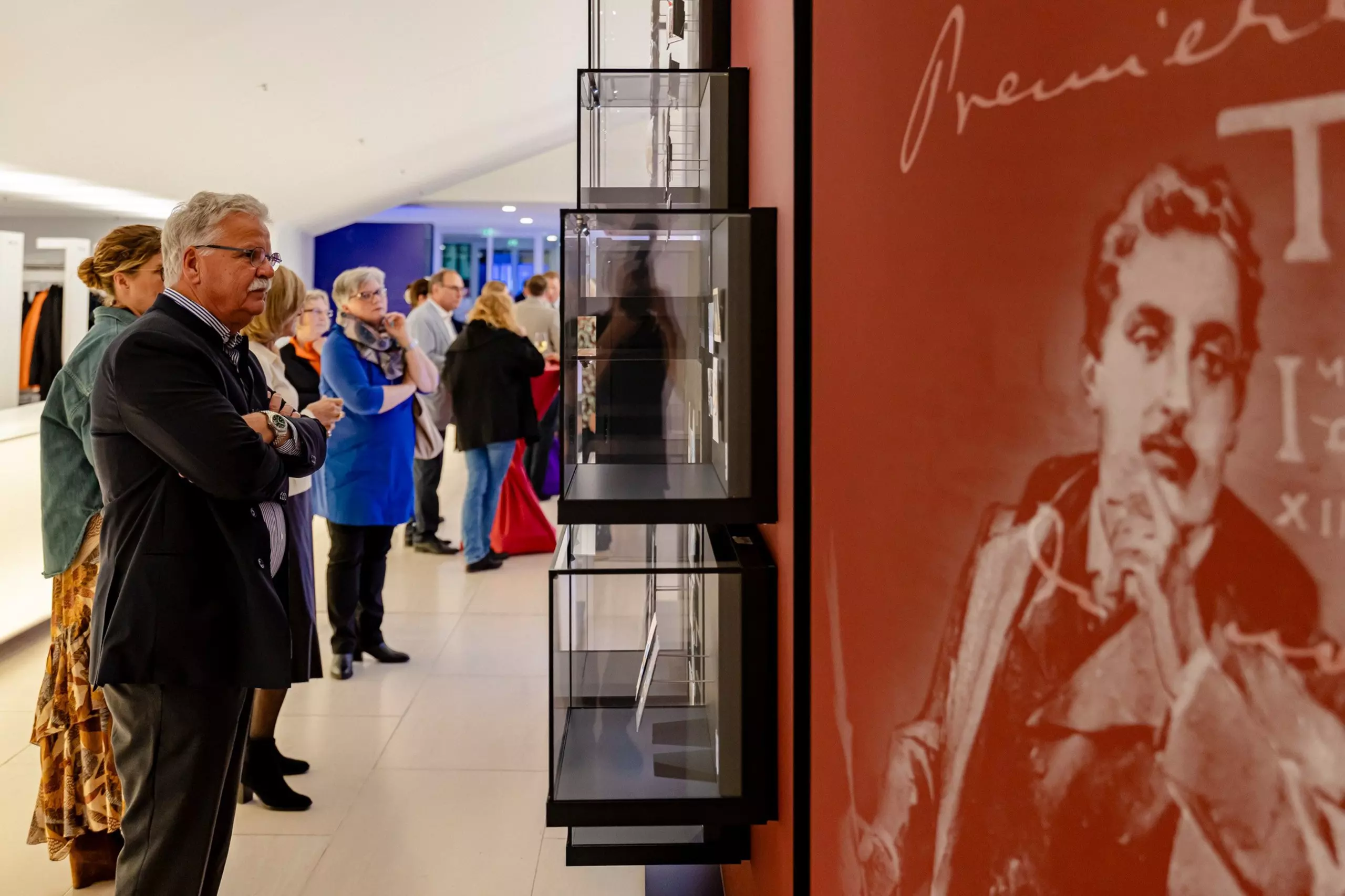 Visitors view the walls and exhibits of the Puccini exhibition “Opera Meets New Media"