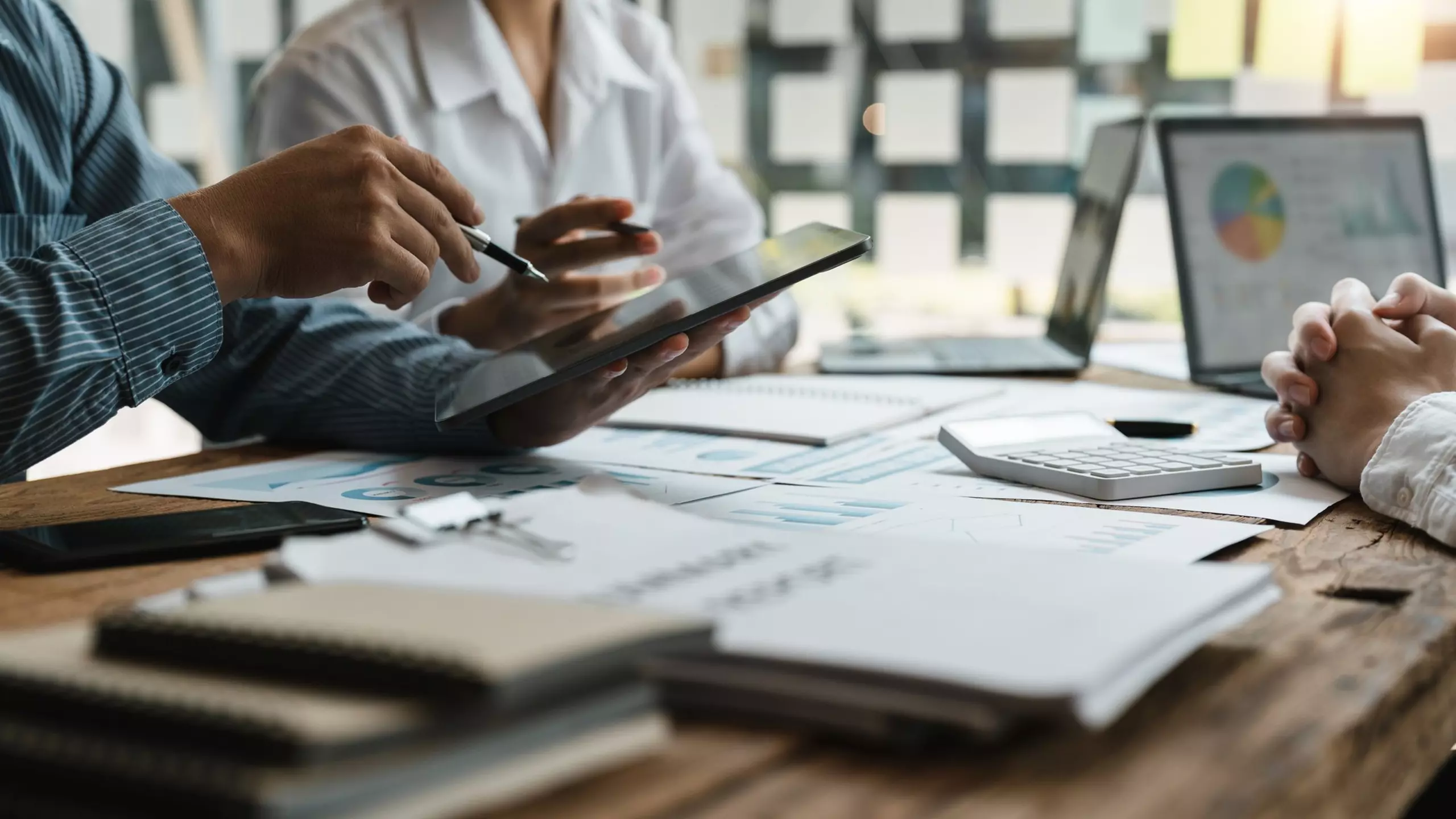 People reviewing documents during a meeting.