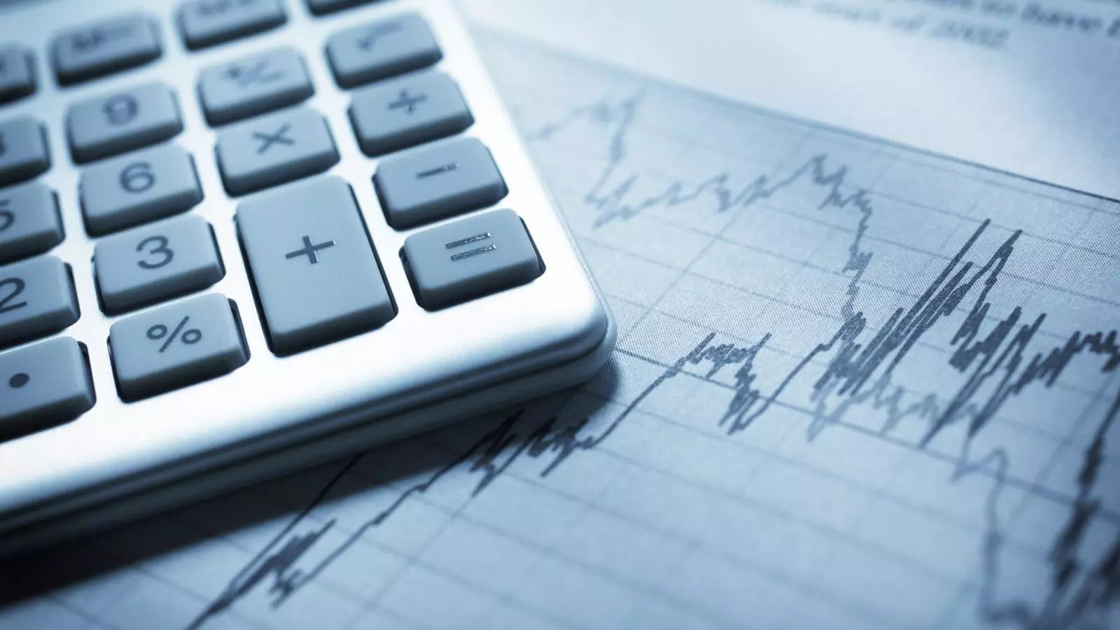 Keyboard with numbers is on a line chart.