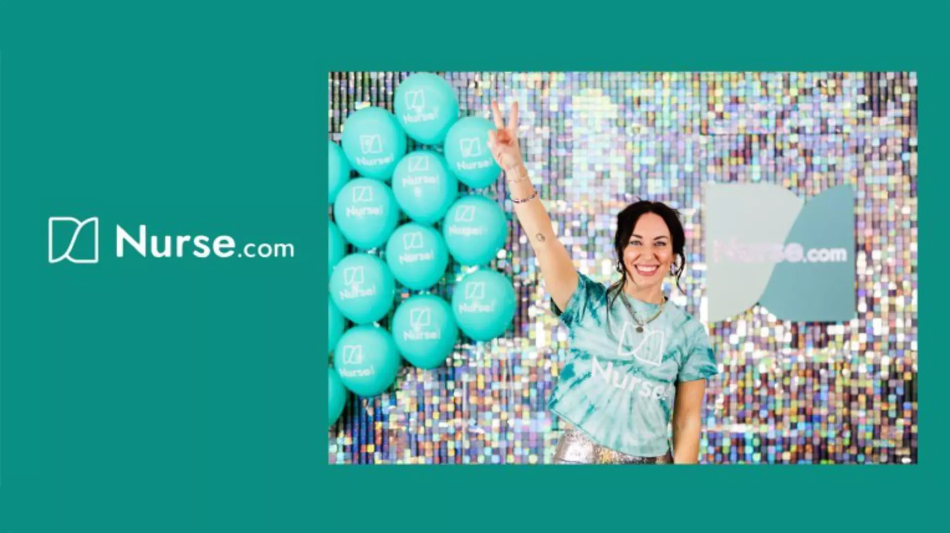 Woman smiles in front of colorful backdrop, raises two fingers, standing beside turquoise balloons with Nurse.com logo.