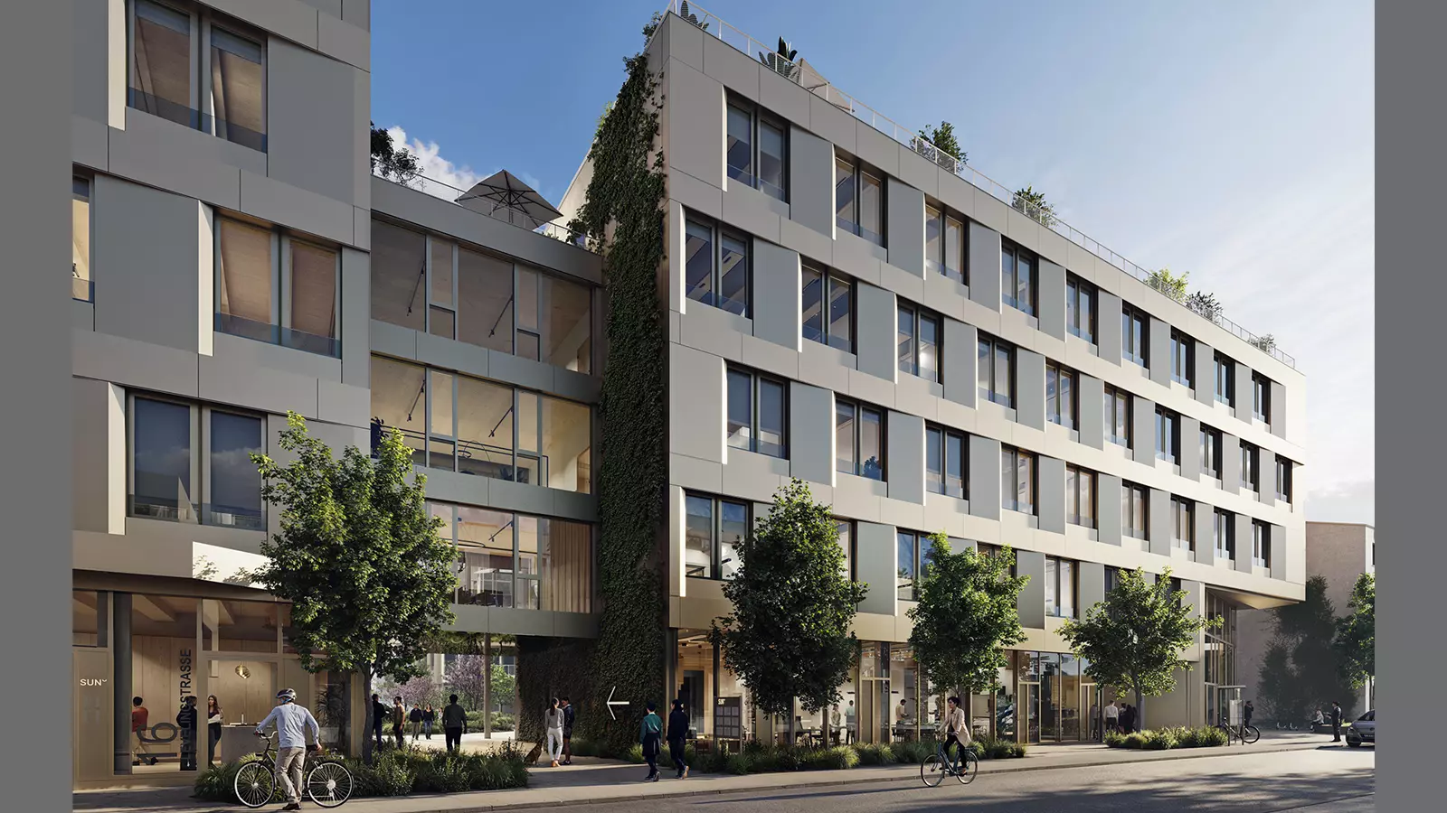 Modern multi‑storey office and commercial building with large windows, a greened facade, and people walking or standing near the entrances.