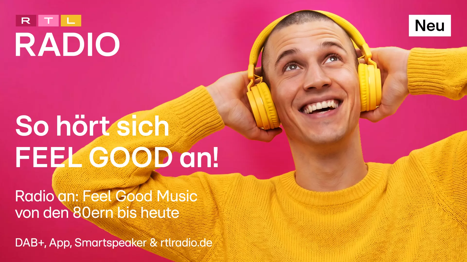 A young man in a yellow sweater and yellow headphones is holding his headphones with both hands and looking up with a smile. The text is set against a pink background, and it’s the RTL Radio logo in red, pink, and yellow, with the caption: “NEW: This is what ‘Feel Good’ sounds like! Tune in to Fell Good Music from the ’80s to today.”