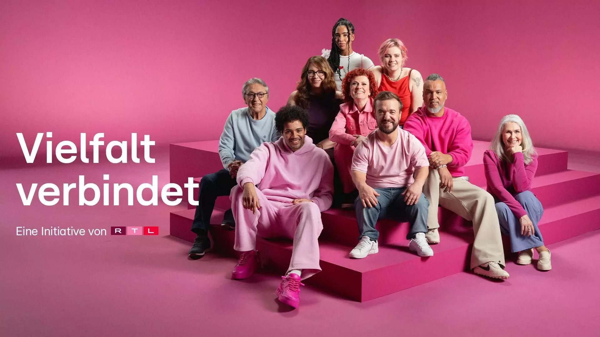 A pink staircase with nine people sitting on it, with the words “Diversity connects” on the left.
